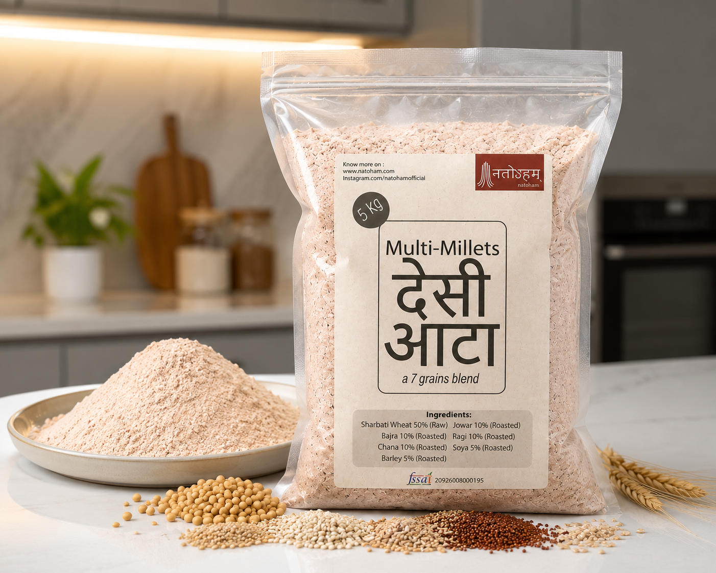 Natoham देसी Atta pack on a kitchen counter with a mound of flour, a plate of grains and wheat stalks